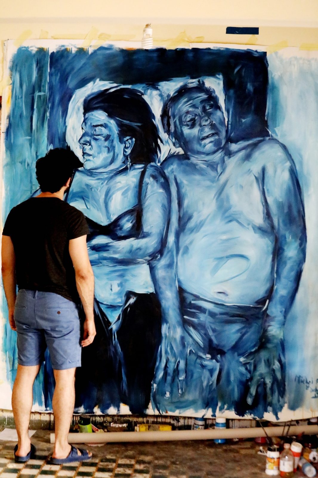The artist standing before Leila and Jalal No. 4 in the studio